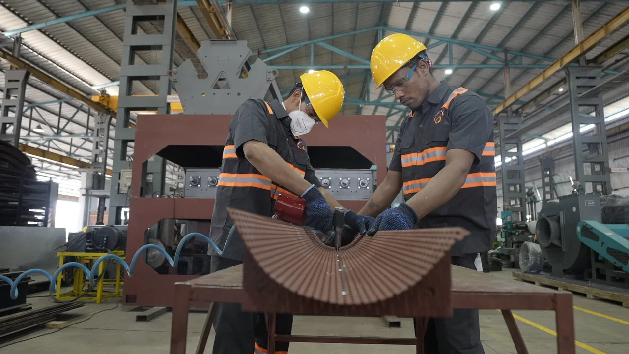 Two members of the Ferro Oiltek fabrication team working on a component